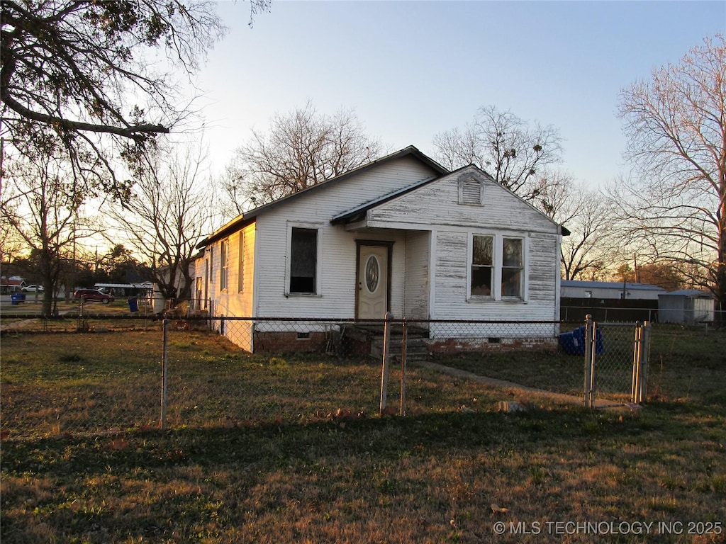 view of front of home with a yard