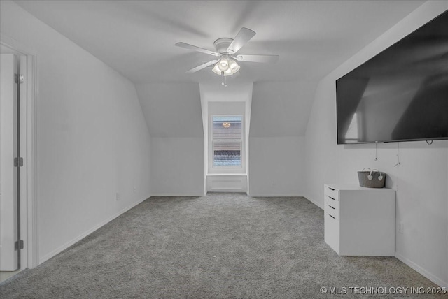 additional living space featuring vaulted ceiling, light colored carpet, and ceiling fan