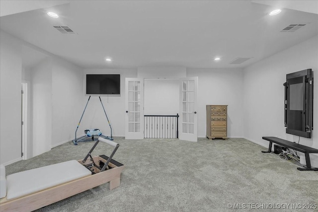 exercise area featuring french doors and light carpet