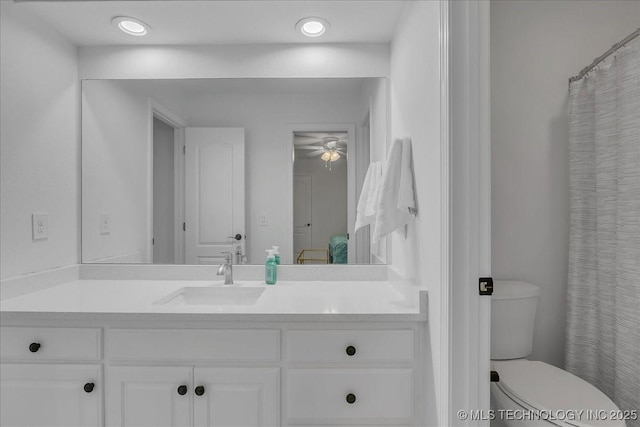 bathroom featuring ceiling fan, vanity, and toilet