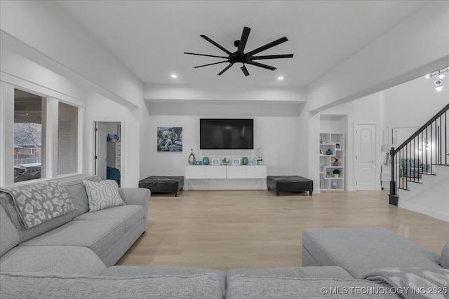 living room with ceiling fan and light hardwood / wood-style floors