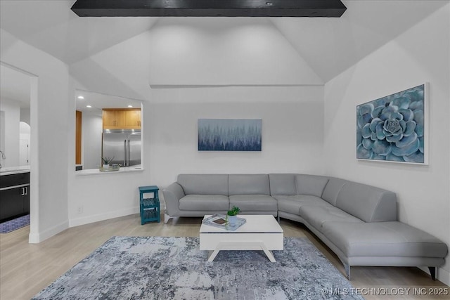 living room with light wood-type flooring and vaulted ceiling