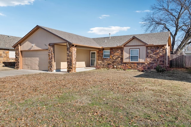 ranch-style home with a front lawn and a garage