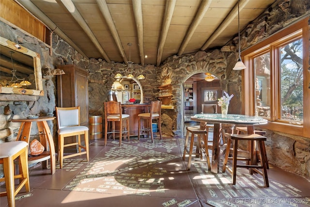 dining room featuring beamed ceiling and wood ceiling