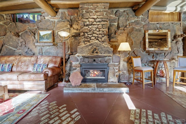 unfurnished living room featuring beamed ceiling, a stone fireplace, dark tile patterned floors, and wood ceiling