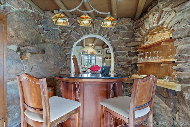 bar with beamed ceiling and wooden ceiling