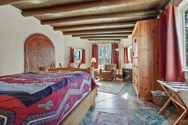 bedroom featuring beamed ceiling and wood ceiling