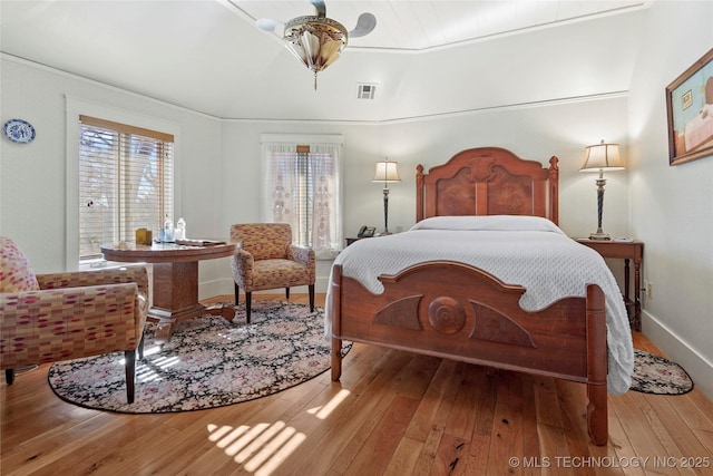 bedroom featuring ornamental molding and light wood-type flooring