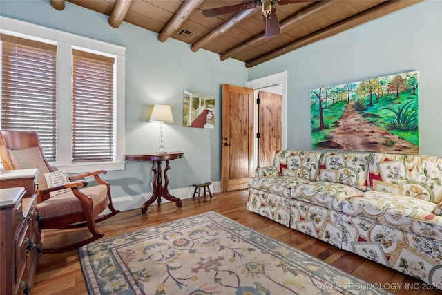 living room with vaulted ceiling with beams, ceiling fan, wood-type flooring, and wood ceiling