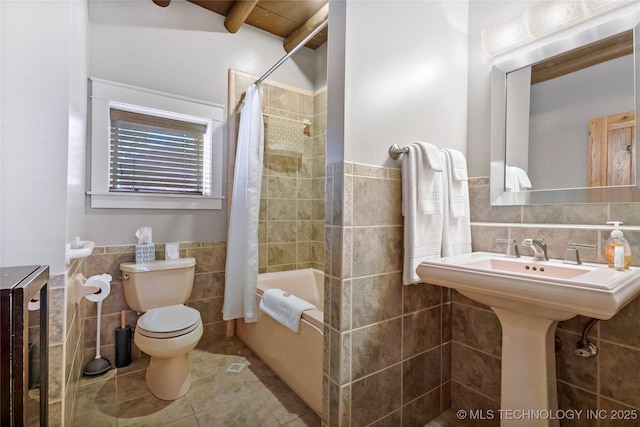 bathroom featuring shower / tub combo with curtain, tile walls, beamed ceiling, tile patterned flooring, and toilet