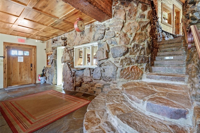 foyer entrance featuring beam ceiling and wooden ceiling