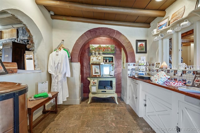 bathroom with beamed ceiling and wooden ceiling