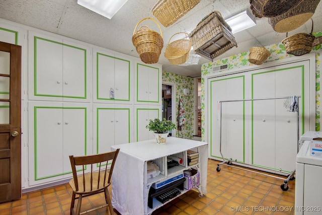 kitchen with a paneled ceiling, washer / clothes dryer, and tile patterned floors