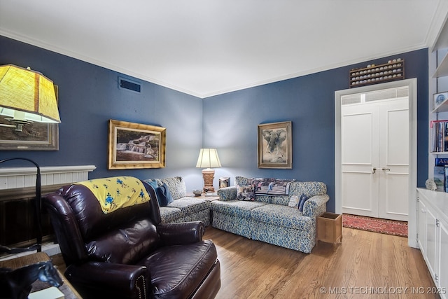 living room with crown molding and hardwood / wood-style floors