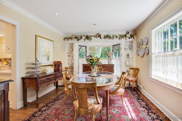 dining space with hardwood / wood-style floors and ornamental molding