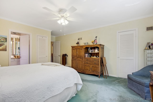 carpeted bedroom with ornamental molding, ensuite bath, ceiling fan, and multiple closets