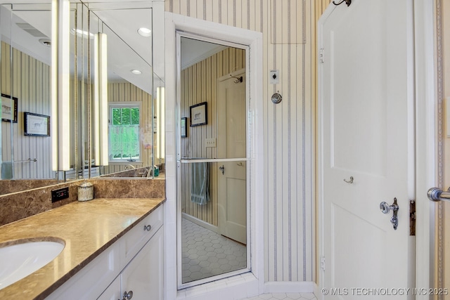 bathroom with tile patterned flooring, vanity, and a shower with shower door