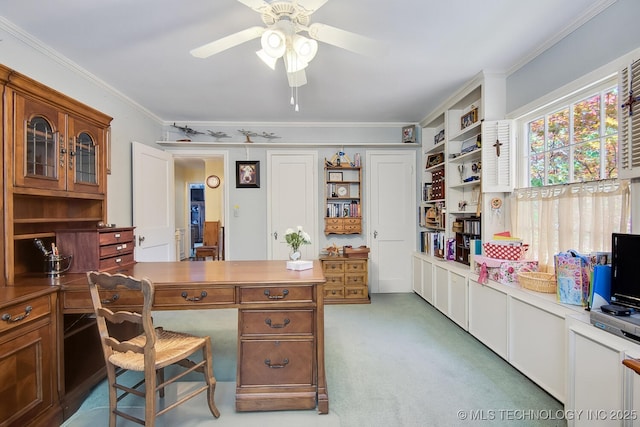 carpeted office featuring ceiling fan and crown molding