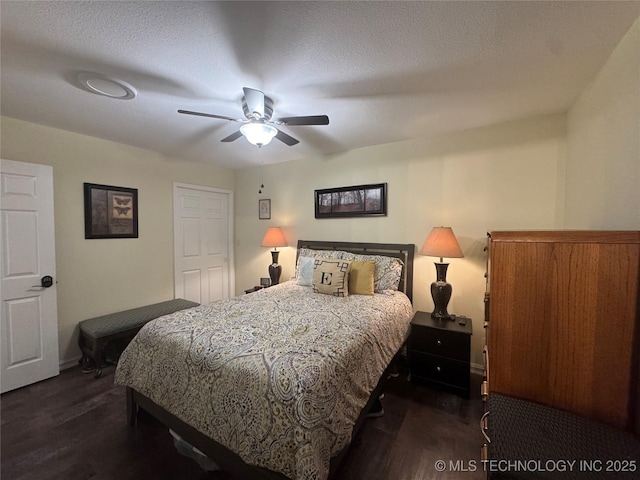 bedroom featuring ceiling fan, dark wood-type flooring, and a textured ceiling