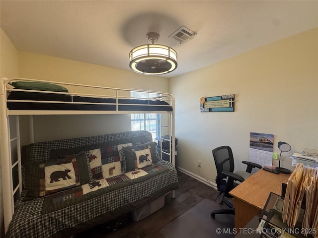 bedroom with dark wood-type flooring