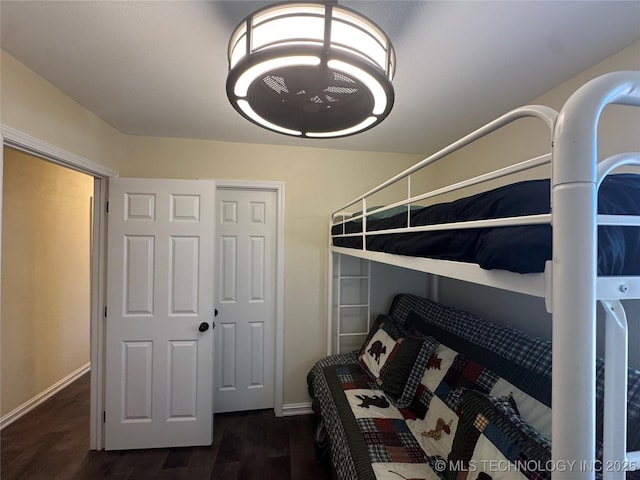 bedroom with a closet and dark hardwood / wood-style flooring