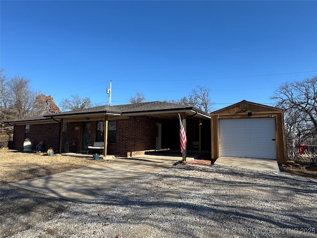 ranch-style house with a garage and an outbuilding