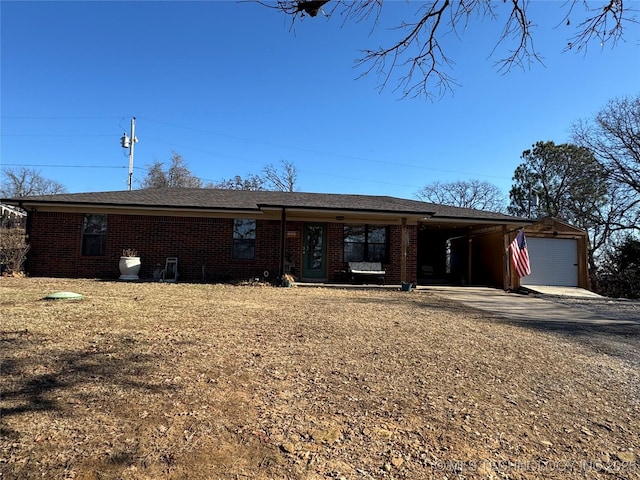 view of front of house featuring a garage, a carport, and an outdoor structure