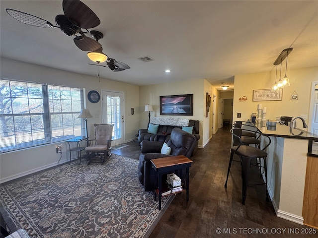 living room with ceiling fan and dark hardwood / wood-style floors