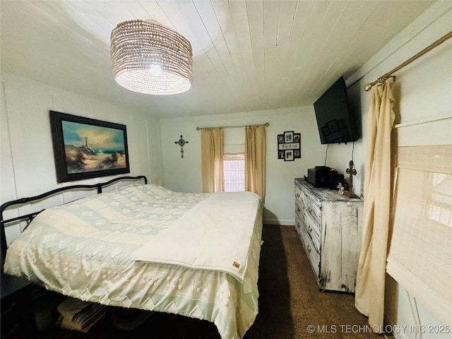 bedroom with dark carpet and wood ceiling