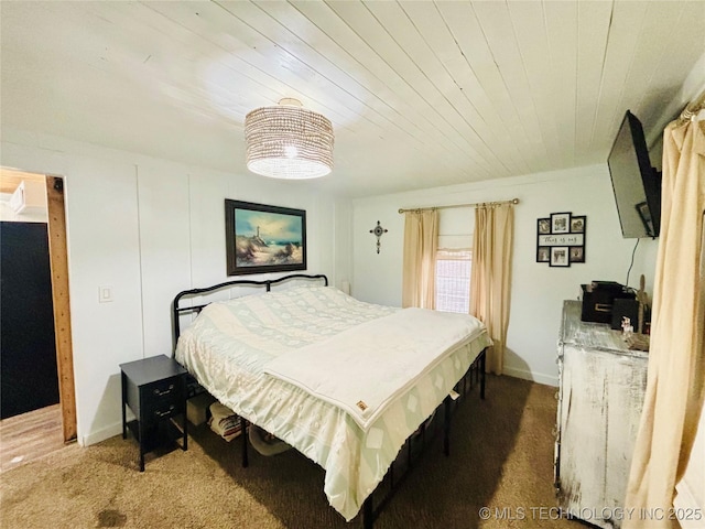 carpeted bedroom featuring wooden ceiling