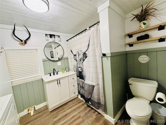 bathroom with wood-type flooring, wooden ceiling, toilet, vanity, and wood walls