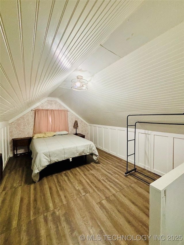 bedroom with hardwood / wood-style flooring and lofted ceiling