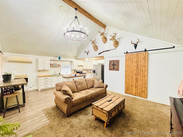 living room featuring sink, light hardwood / wood-style floors, vaulted ceiling with beams, an inviting chandelier, and a wall mounted AC