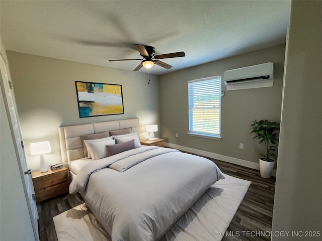 bedroom featuring ceiling fan, dark hardwood / wood-style flooring, a textured ceiling, and a wall unit AC