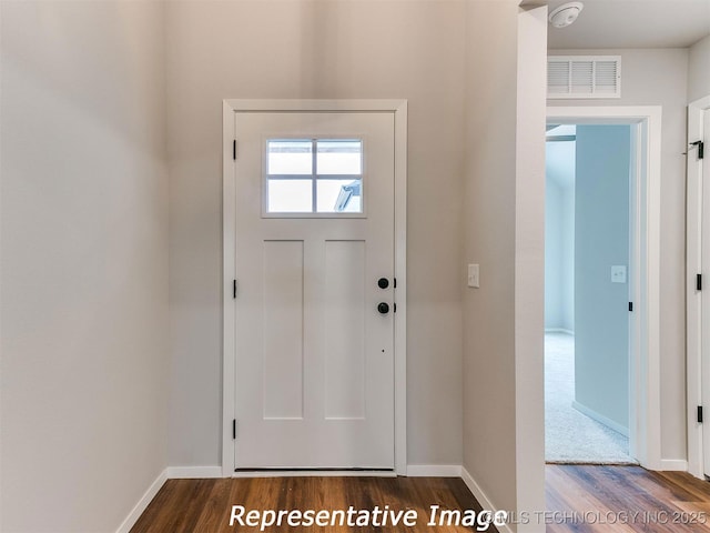 entryway with dark hardwood / wood-style flooring