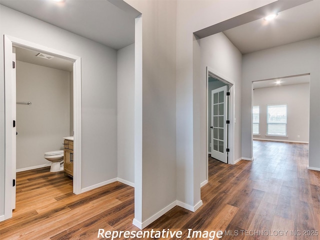 hall with hardwood / wood-style flooring