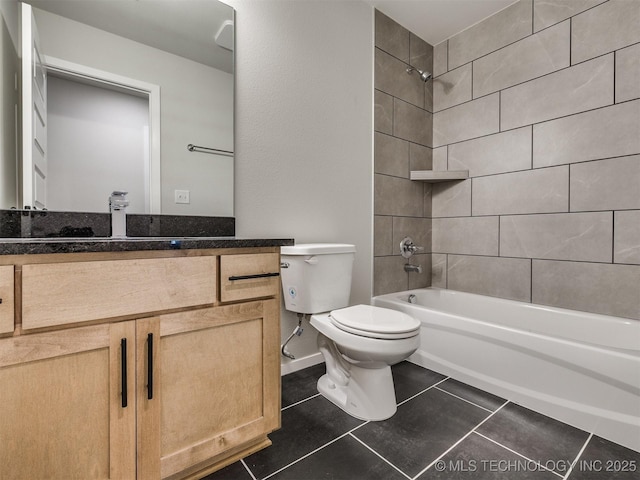 full bathroom featuring tile patterned floors, toilet, vanity, and tiled shower / bath