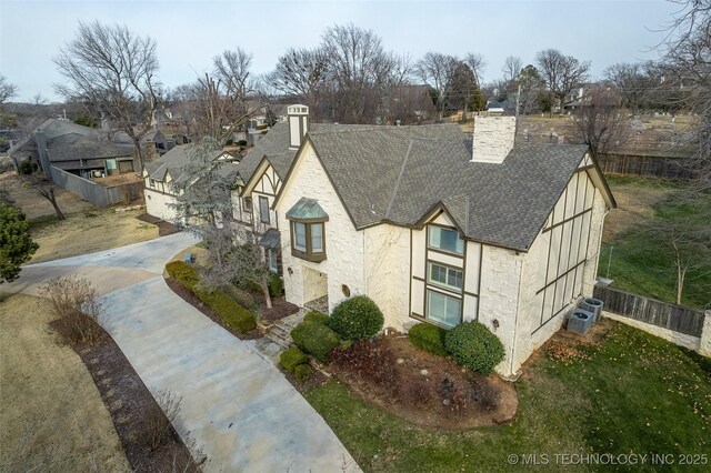 tudor home featuring central air condition unit