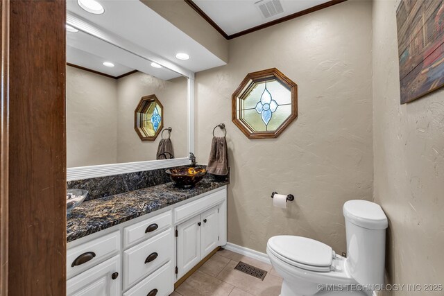 bathroom with crown molding, vanity, toilet, and tile patterned flooring