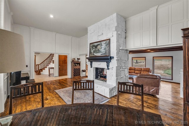 living room with wood-type flooring and a fireplace