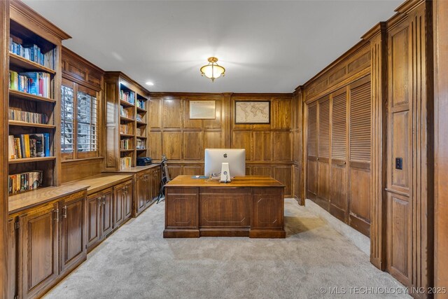 office space featuring light colored carpet and wood walls