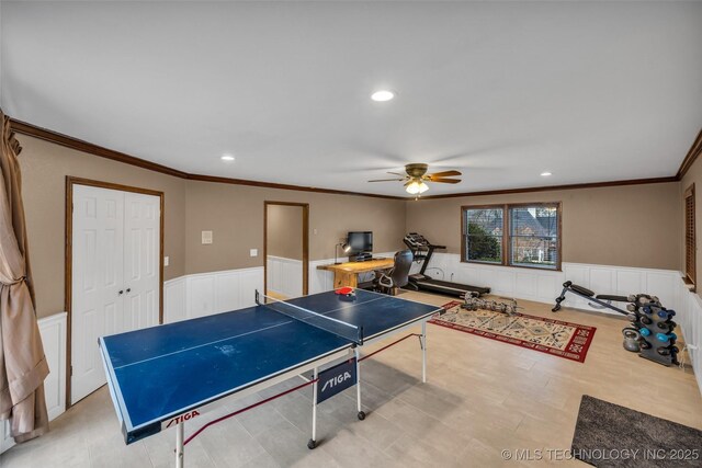 recreation room featuring ornamental molding and ceiling fan