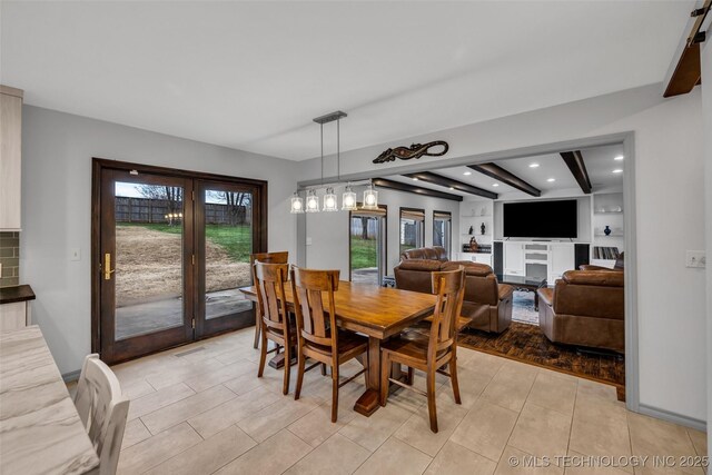 dining space with beamed ceiling and light tile patterned floors