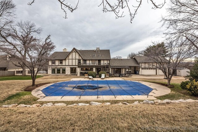 view of pool with a lawn and a patio