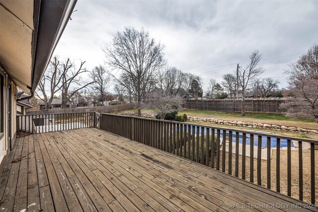 wooden deck with a covered pool