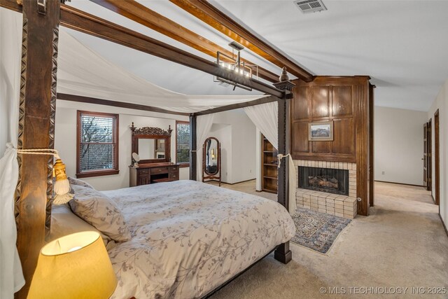 carpeted bedroom with a fireplace