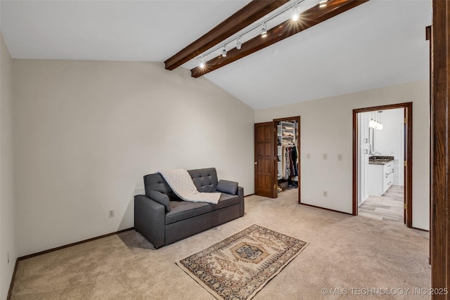 carpeted living room with vaulted ceiling with beams and rail lighting