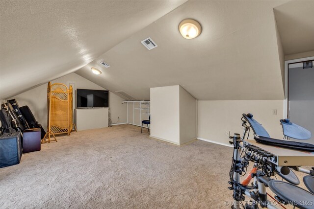 workout room with lofted ceiling and carpet