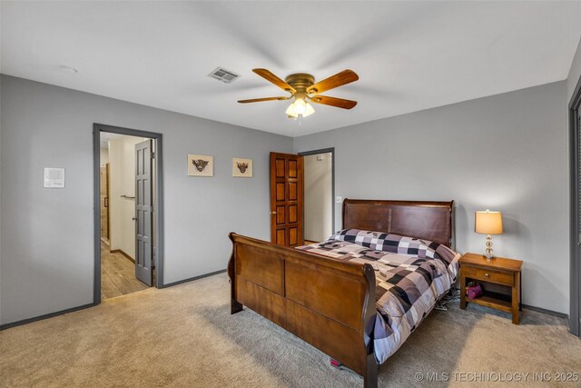 bedroom with ceiling fan and light carpet