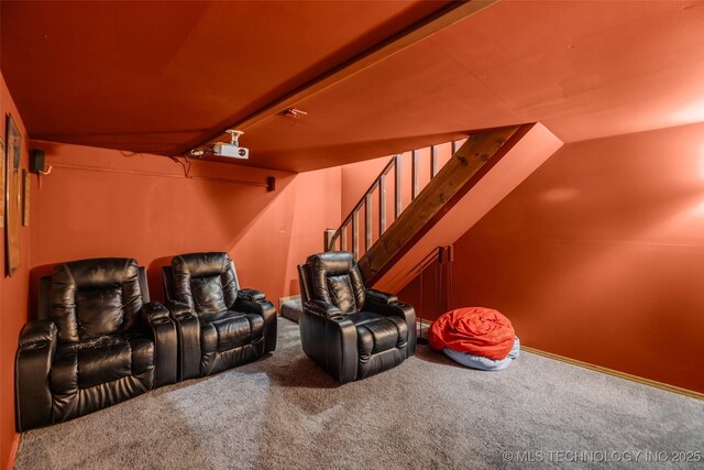 carpeted home theater room with lofted ceiling